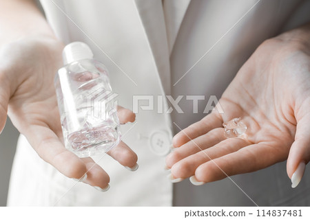 Women washing hands with antibacterial sanitizer gel. Hygiene concept. Prevent the spread of germs and bacteria and avoid infections corona virus 114837481