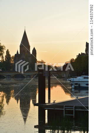 Metz, France. A view of the Temple Neuf along the Moselle River at sunrise on May 10, 2024. 114837892