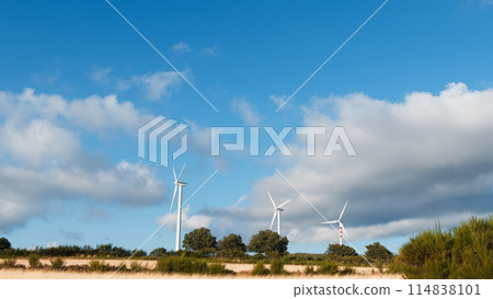 Wind Turbines Surrounded By Blue Sky Wind Turbines Surrounded By Blue Sky 114838101
