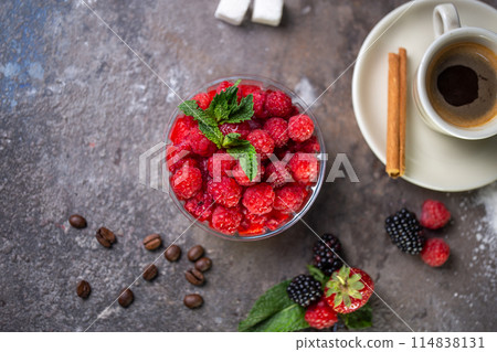 panakota dessert with fresh raspberries and a cup of coffee on a concrete background top view 114838131