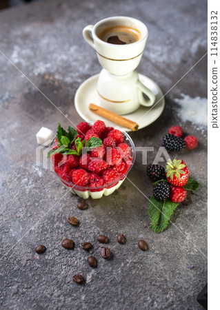 panakota dessert with fresh raspberries and a cup of coffee on a concrete background top view 114838132
