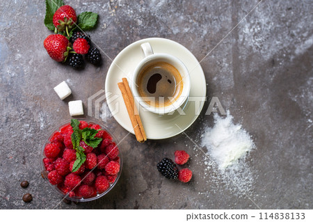 panakota dessert with fresh raspberries and a cup of coffee on a concrete background top view panakota dessert with fresh raspberries and a cup of coffee on a concrete background top view 114838133