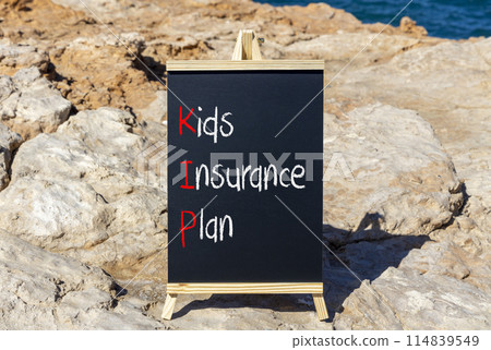 KIP kids insurance plan symbol. Concept words KIP kids insurance plan on beautiful yellow blackboard. Beautiful stone blue sky sea background. Business KIP kids insurance plan concept. Copy space. 114839549