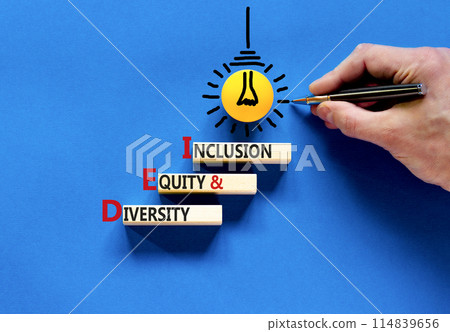 DEI diversity equity and inclusion symbol. Concept words DEI diversity equity and inclusion on blocks. Beautiful blue background. Business DEI diversity equity and inclusion concept. Copy space. 114839656