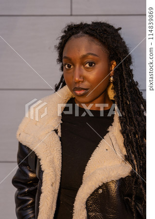 Fashionable Black Woman in Stylish Faux Fur Coat exudes confidence and modern urban style Fashionable Black Woman in Stylish Faux Fur Coat exudes confidence and modern urban style 114839869