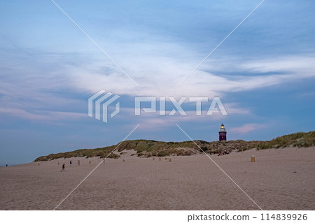 Evening Stroll by the Dunes with Distant Lighthouse View 114839926