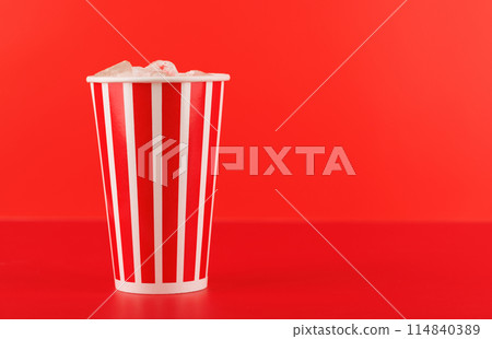 Paper cup with cola and ice over red background 114840389