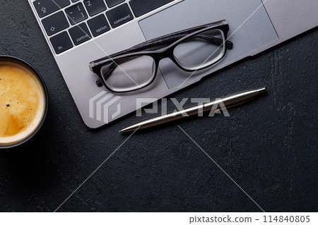 Office desk table with laptop, cup of coffee and supplies Office desk table with laptop, cup of coffee and supplies 114840805