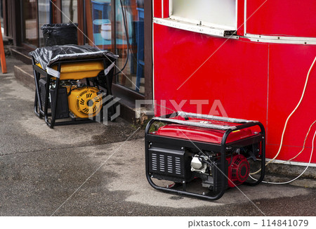Portable electric generator running in the cold winter.Energy genocide. Power outage as a result of missile strikes by Russia on energy facilities of Ukraine. Small business use gasoline generators Portable electric generator running in the cold winter.Energy genocide. Power outage as a result of missile strikes by Russia on energy facilities of Ukraine. Small business use gasoline generators 114841079