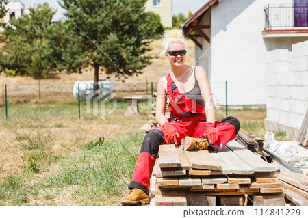 Woman taking break on construction site Woman taking break on construction site 114841229