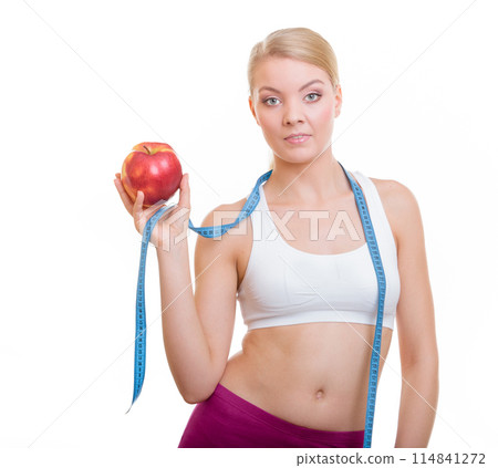 Diet. Fit girl with measure tape and apple fruit Diet. Fit girl with measure tape and apple fruit 114841272