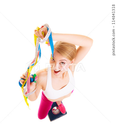 Happy woman on weighing scale. Diet weight loss. 114841318