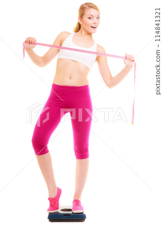 Happy woman on weighing scale. Diet weight loss. Happy woman on weighing scale. Diet weight loss. 114841321