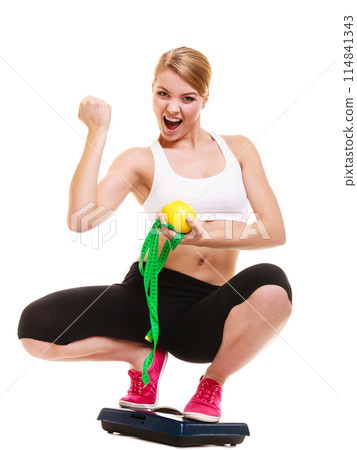 Happy successful woman weighing scale. Weight loss 114841343