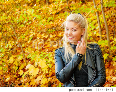 Fashion woman relaxing in autumn park Fashion woman relaxing in autumn park 114841671