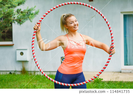 Young woman with hoola hoop outdoors 114841735