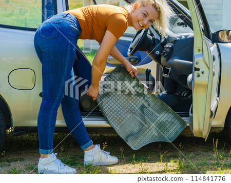 Woman cleaning car interior 114841776