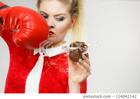 Woman boxing chocolate cupcake 114842142