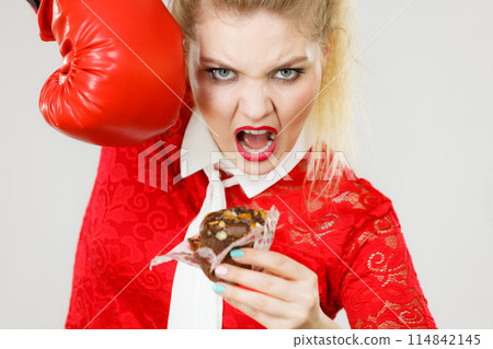 Woman boxing chocolate cupcake 114842145