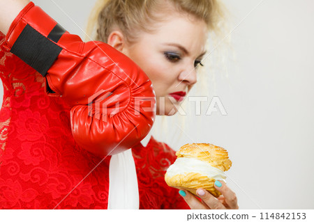Woman boxing cream cupcake 114842153