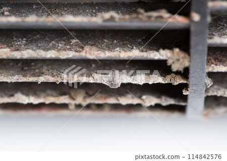 Close-up of dirt, mold and dust on an air conditioner fan Close-up of dirt, mold and dust on an air conditioner fan 114842576