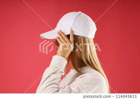 A young woman in a white sweater 114843613