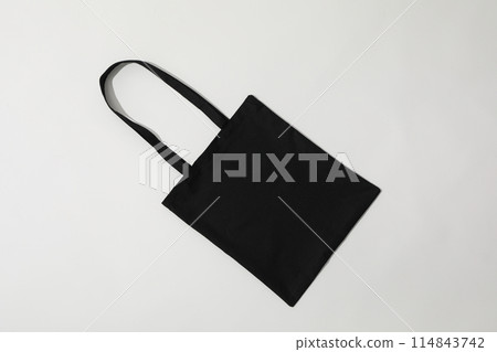 A black bag lies on a white background 114843742