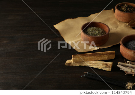 A set of magical things on a dark table. 114843794