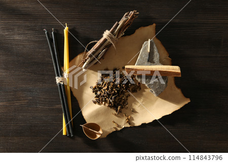 A set of magical things on a dark table. 114843796