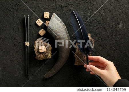 A set of magical things on a dark table. 114843799