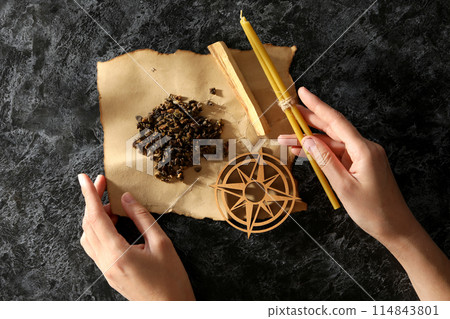 A set of magical things on a dark table. 114843801