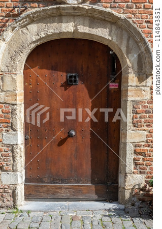 Rustic Medieval Wooden Door with Stone Archway, bathed in Sunlight, timeless ancient architecture Rustic Medieval Wooden Door with Stone Archway, bathed in Sunlight, timeless ancient architecture 114843851