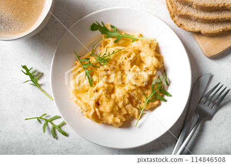 Scrambled eggs on white plate 114846508