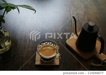 coffee in a glass cup on dark brown wooden table coffee in a glass cup on dark brown wooden table 114846677