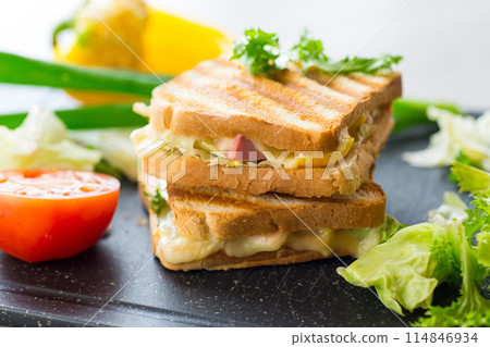 fried toasts with filling, salad leaves, tomatoes fried toasts with filling, salad leaves, tomatoes 114846934