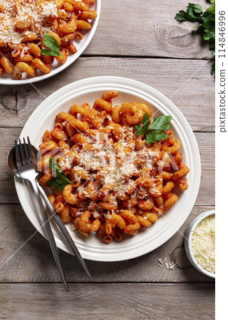 Cavatappi pasta with tomato sauce and parmesan cheese Cavatappi pasta with tomato sauce and parmesan cheese 114846996