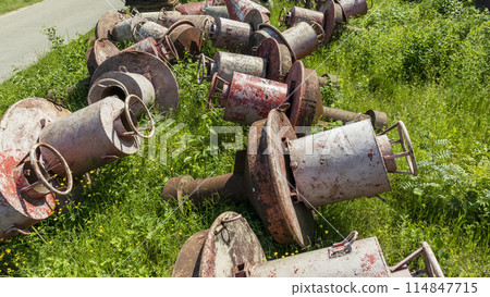old and rusty used and lie on the Bank in the grass old and rusty used and lie on the Bank in the grass 114847715