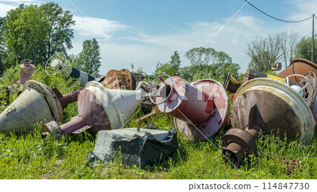 old and rusty used and lie on the Bank in the grass old and rusty used and lie on the Bank in the grass 114847730