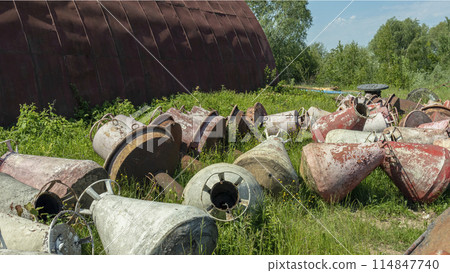 old and rusty used and lie on the Bank in the grass old and rusty used and lie on the Bank in the grass 114847740