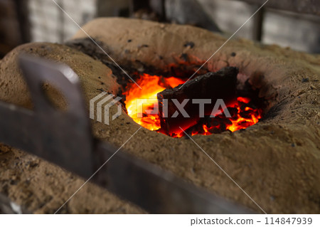 Ferrous metal billet is melted in an induction furnace closeup Ferrous metal billet is melted in an induction furnace closeup 114847939