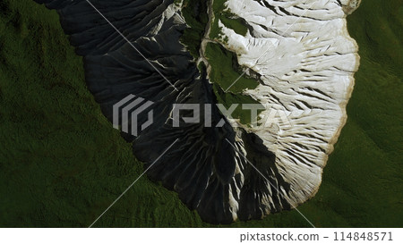 Top view of picturesque mountain peak. Clip. Frozen stone formations and green grass. Top view of picturesque mountain peak. Clip. Frozen stone formations and green grass. 114848571