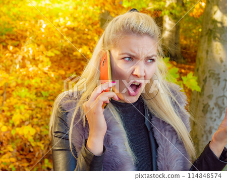 Fashion girl talking on mobile phone outdoor Fashion girl talking on mobile phone outdoor 114848574