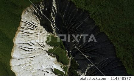 Contrasting green vegetation and white stony mountain peak. Clip. Aerial top view of stunning nature masterpiece. 114848577