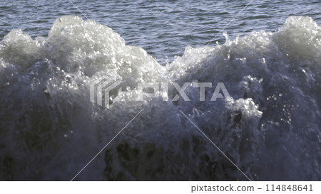 Slow motion of ocean waves crashing on beach. Creative. Beauty of nature. 114848641