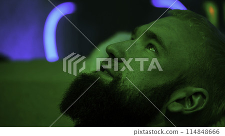 Portrait of a young blond man with beard looking up and talking to somebody. Media. Young man having conversation. 114848666