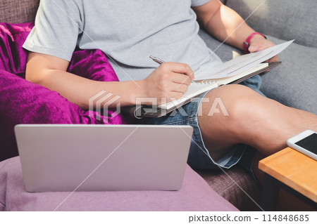 A man in casual wear is working at home office. 114848685