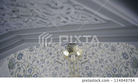 Interior design of mosque with carved walls and blue and white flowers on the ceiling. Scene. Concept of religion and architecture. Interior design of mosque with carved walls and blue and white flowers on the ceiling. Scene. Concept of religion and architecture. 114848784