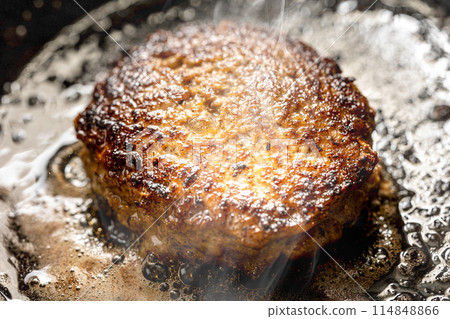 Hamburger cooked in a frying pan Hamburger cooked in a frying pan 114848866