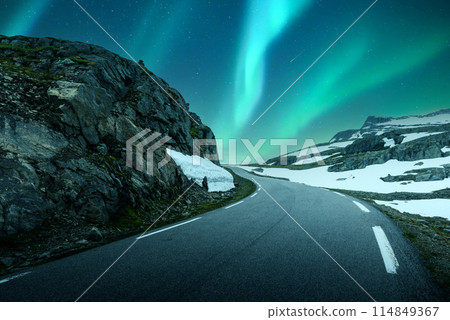 Northern lights above the famous mountain snowy road in Norway 114849367