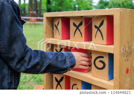 Close-Up hand of child playing Tic-Tac-Toe outdoors Close-Up hand of child playing Tic-Tac-Toe outdoors 114849821